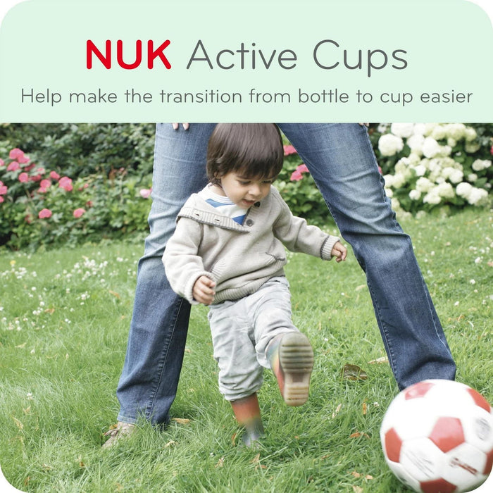 NUK Active Cups shown in an outdoor setting with a toddler kicking a soccer ball on grass.