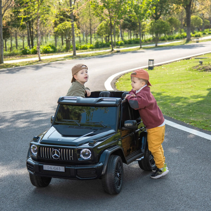 Kids electric ride-on Mercedes G63 car with two children playing outdoors on a sunny day.