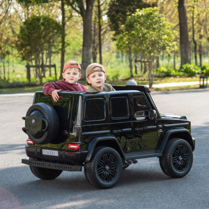 Kids electric ride-on SUV car outdoors with two children sitting inside, black model on paved road.