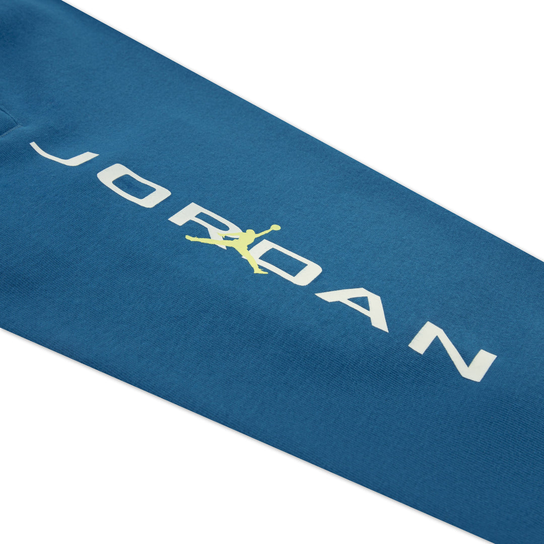 Jordan kids' blue sweatshirt sleeve showing white logo and yellow Jumpman graphic.