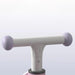 Pink and white scooter handlebar with purple rubber grips against a plain background.