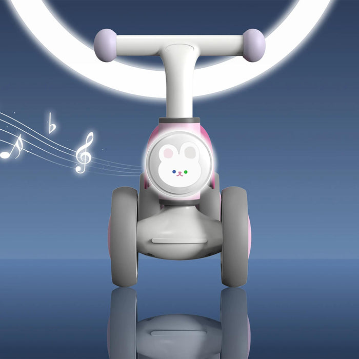 Pink and white toddler ride-on toy bike with bunny face and musical notes, shown on a blue background.