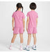 Kids pink short sleeve t-shirt and shorts set modeled by two children standing side by side, back view.