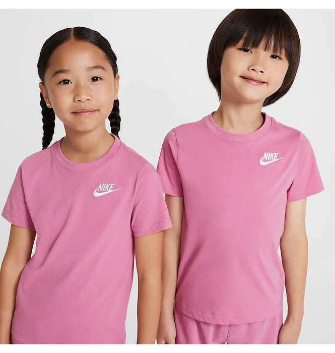 Nike kids' pink t-shirts worn by two children standing together against a plain background.