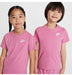 Nike kids' pink t-shirts worn by two children standing together against a plain background.