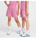 Nike kids’ pink shorts and t-shirts modeled by two children standing on a white background.