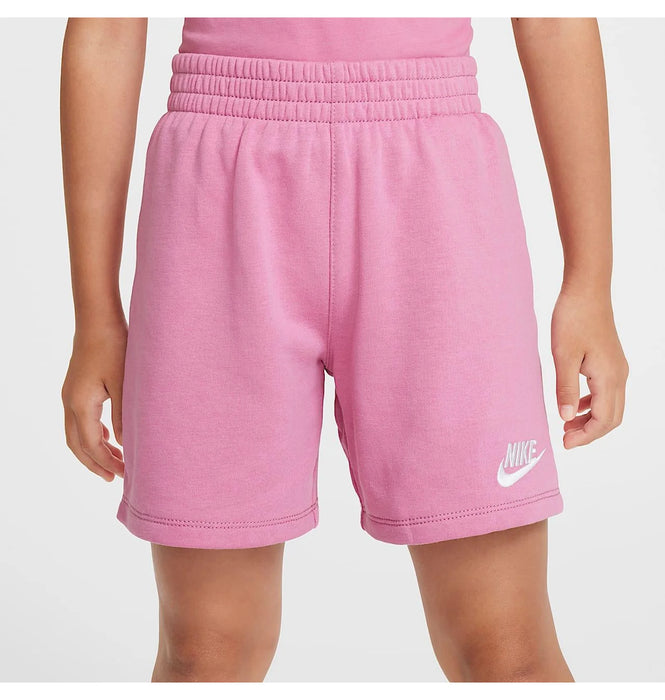 Nike kids' pink shorts with logo, shown worn by a child against a neutral background.