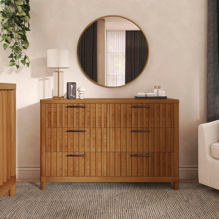 Modern wooden dresser with six drawers, round mirror, lamp, nursery decor, and neutral tones