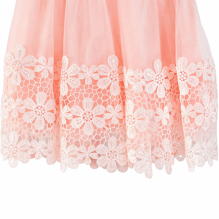 Peach dress with floral lace hem shown in close-up, highlighting delicate embroidery details.