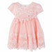 Peach baby dress with lace floral embroidery and pearl accents displayed on a white background.