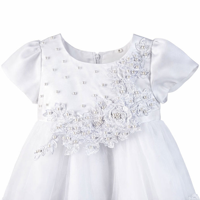 White baby dress with floral lace appliqué and pearls shown on a plain background.