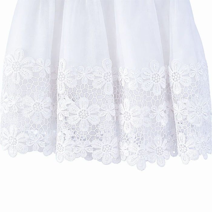 White girls' dress with floral lace hem detail shown close up against a white background.
