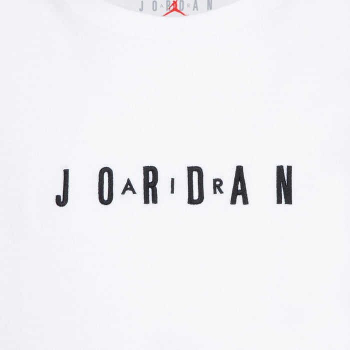 Jordan white t-shirt with black embroidered logo letters across the chest, close-up view.