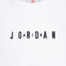 Jordan white t-shirt with black embroidered logo letters across the chest, close-up view.