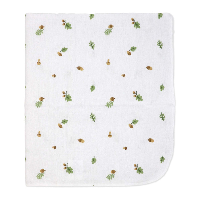 Baby muslin blanket with green leaf and acorn print displayed flat on a white background.