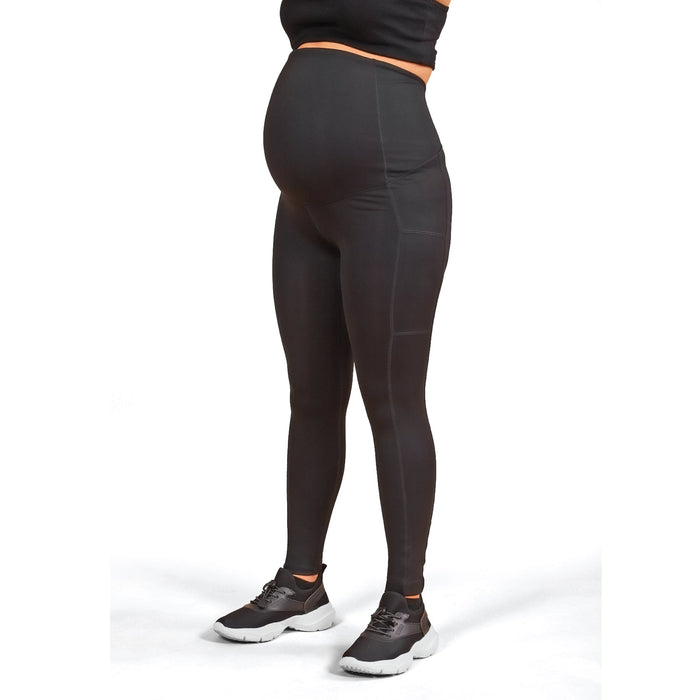ATHENA black maternity leggings shown on a pregnant model standing against a white background.