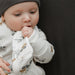 Baby wearing a construction patterned outfit with a dark background