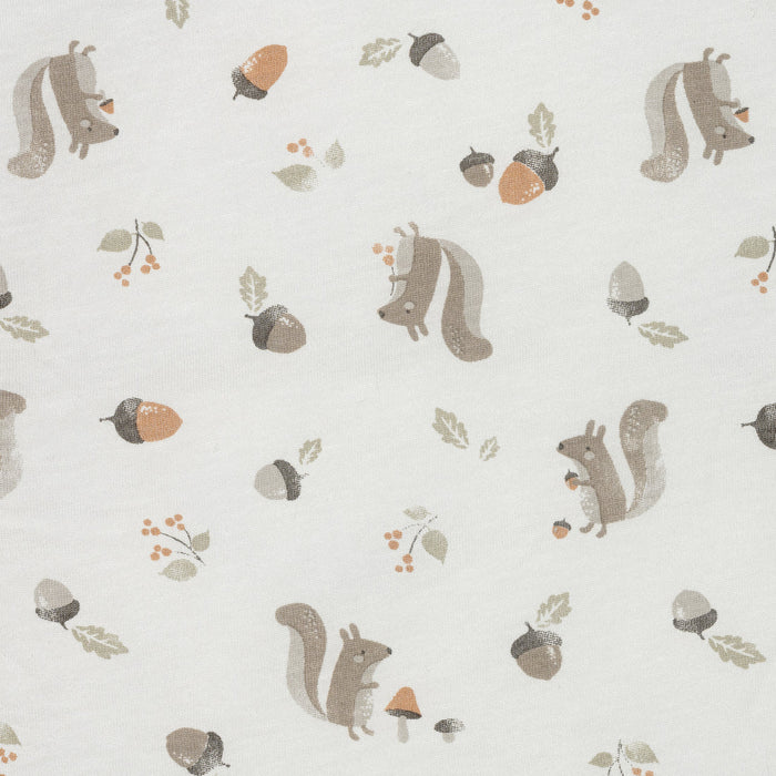 Neutral baby sleeper fabric with squirrels, acorns, leaves, and berries print on white background
