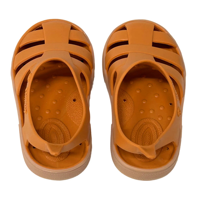 Boatilus Bioty kids sandals in orange shown from above on a white background.