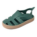 Boatilus Bioty kids sandal in green with tan sole, displayed on a white background.