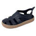 Boatilus Bioty kids sandal in navy blue with a tan sole shown on a plain white background.