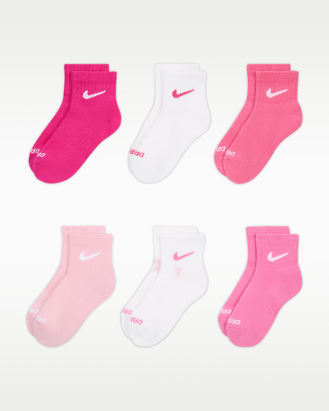 Nike kids’ quarter socks in pink and white, six pairs displayed on a white background.