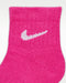 Pink quarter sock with white logo, close-up showing knit texture and ankle cuff.