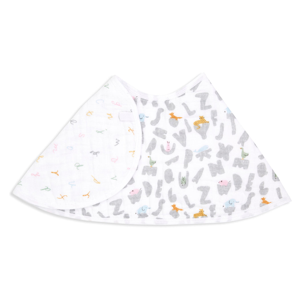Baby muslin bib with grey alphabet and animal print, soft white fabric, laid flat