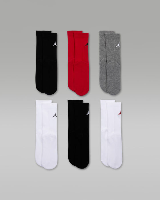 Jordan Everyday Essentials 6-pack crew socks in black, red, grey, and white pairs on a grey background.