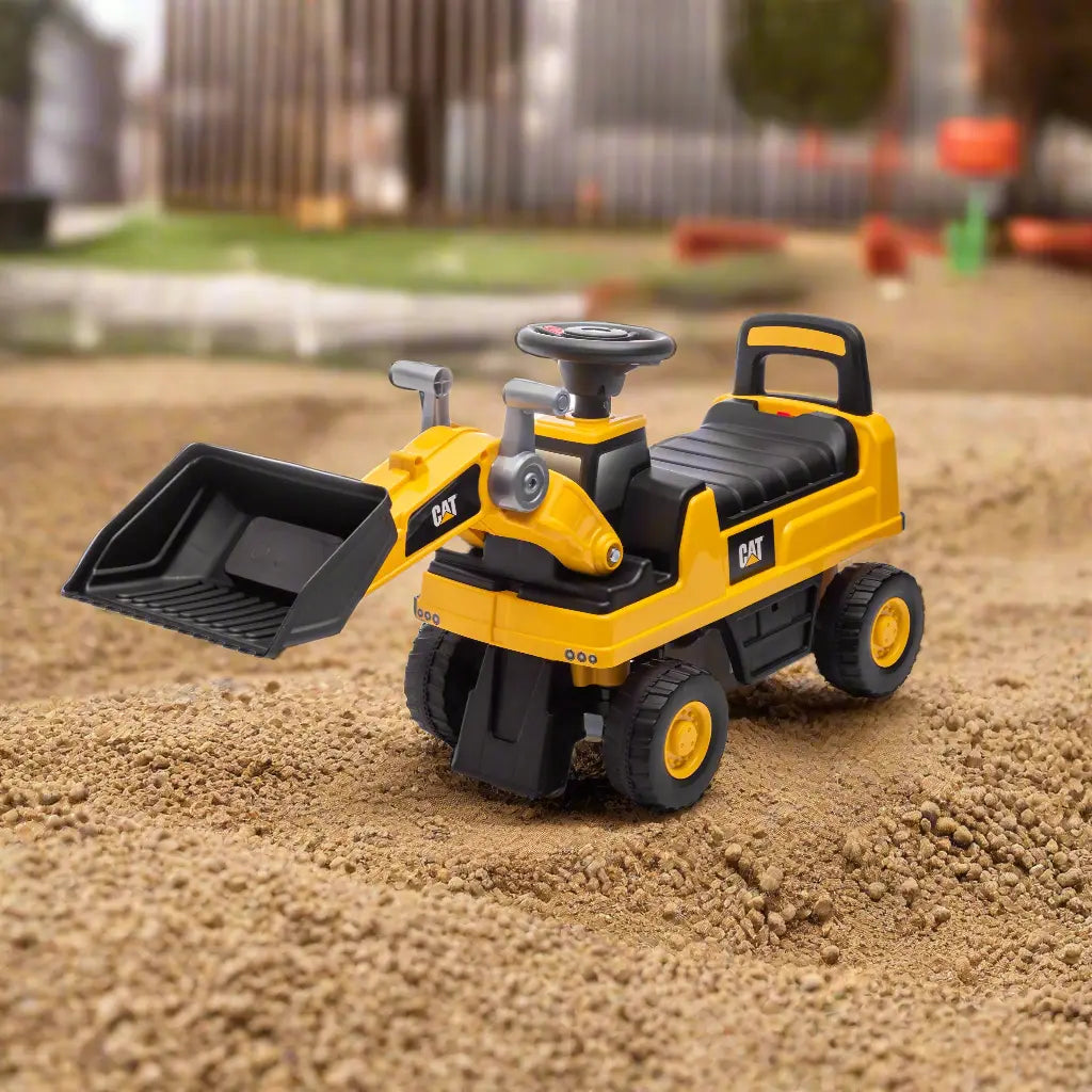 CAT ride-on toy excavator for kids shown on outdoor sand with working scoop bucket.
