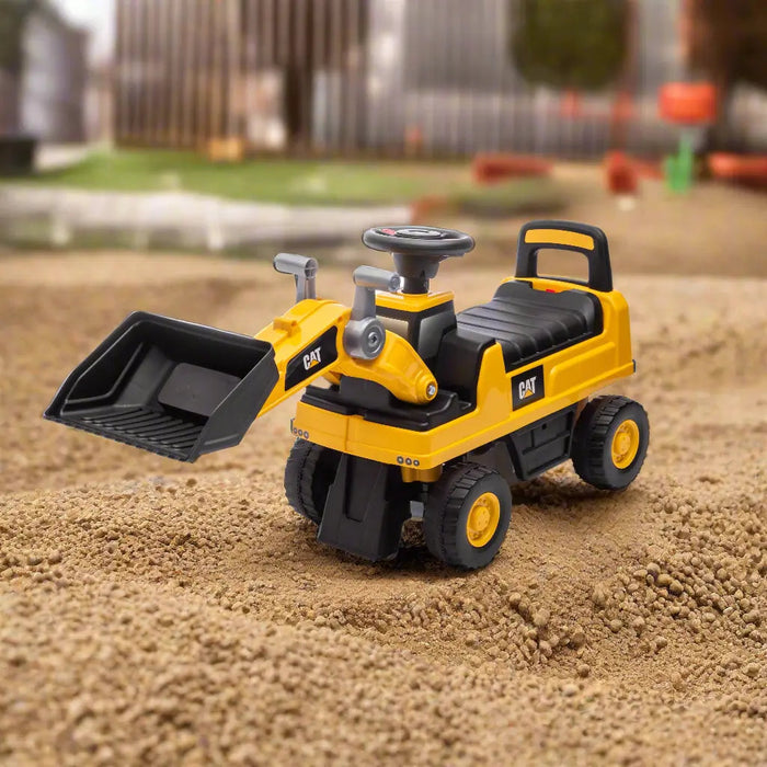 CAT ride-on toy excavator for kids shown on outdoor sand with working scoop bucket.