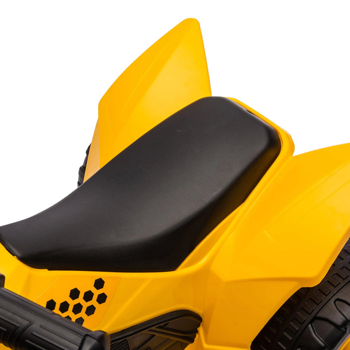 Yellow ride-on toy bike close-up showing black seat and handlebar details.