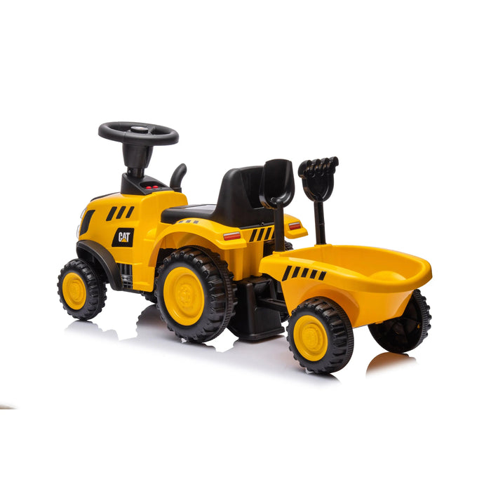 CAT yellow ride-on toy tractor for kids with trailer and shovel shown on white background.