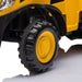 Kids toy truck close-up showing large yellow and black plastic wheel on white background.