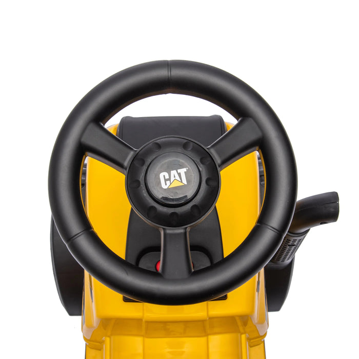 CAT ride-on toy steering wheel and dashboard, close-up view in yellow and black.