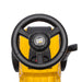 CAT ride-on toy steering wheel and dashboard, close-up view in yellow and black.