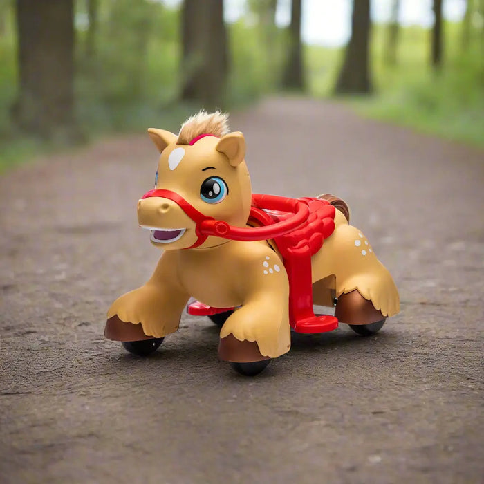 Children’s ride-on horse toy with red saddle and wheels shown outdoors on a forest path.