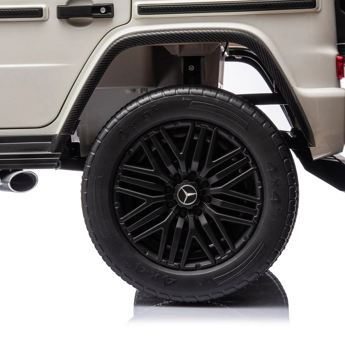 Kids ride-on Mercedes G-Wagon rear wheel and fender in close-up studio view.