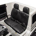 Ride-on toy car black interior seats with seatbelt, shown inside a white vehicle body.