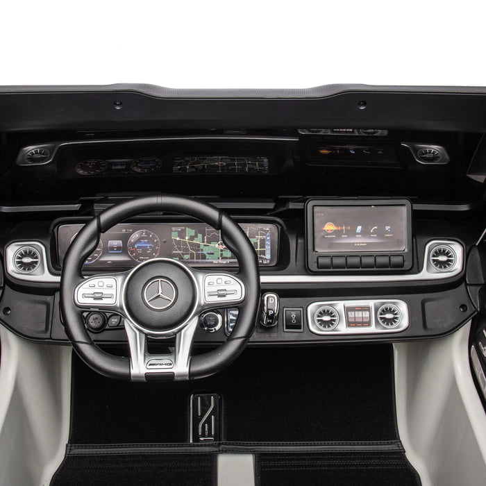 Mercedes kids ride-on car dashboard featuring steering wheel, digital displays, and detailed controls.