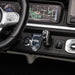 Children’s ride-on car dashboard close-up showing steering wheel, gear selector, and navigation screen.