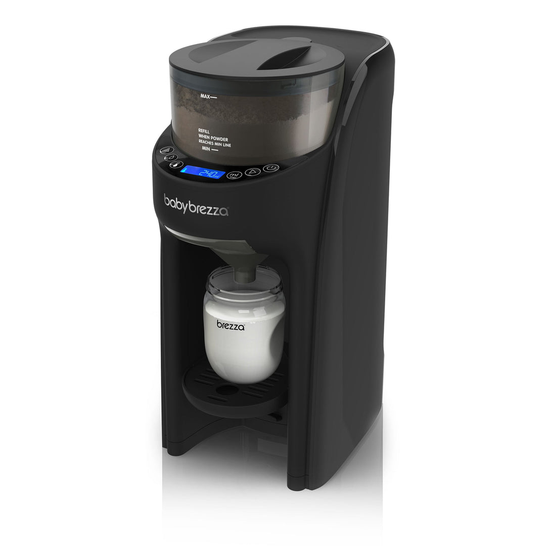 Baby Brezza formula maker in black shown preparing a bottle of baby formula on a white background.