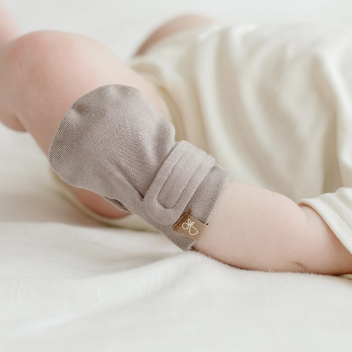Cute baby's hand with Pewter colour Goumi anti-scratch mitts on