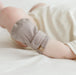 Cute baby's hand with Pewter colour Goumi anti-scratch mitts on