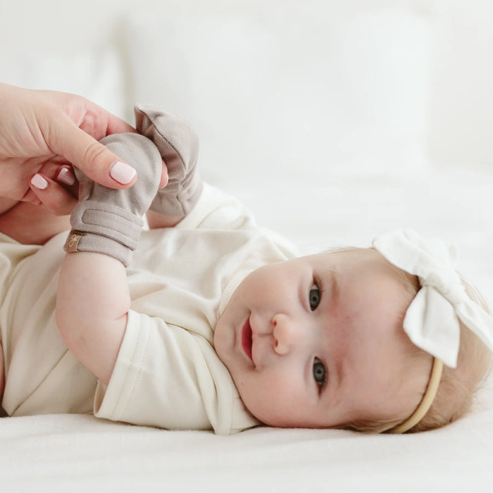 Cute baby girl smiling with mommy holding baby's hands wearing Goumi anti-scratch mitts Pewter - Goldtex