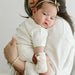 Baby in his mother's arms wearing the Goumi anti-scratch mitts Terrazzo - Goldtex