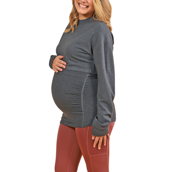 HERA grey maternity top shown on a pregnant woman standing against a white background.