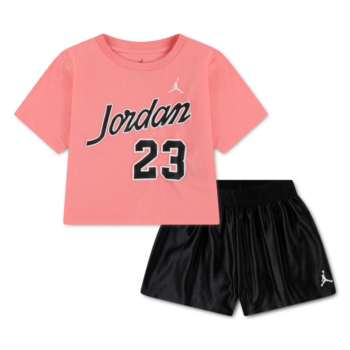 Jordan kids' outfit with pink t-shirt and black shorts displayed on a white background.