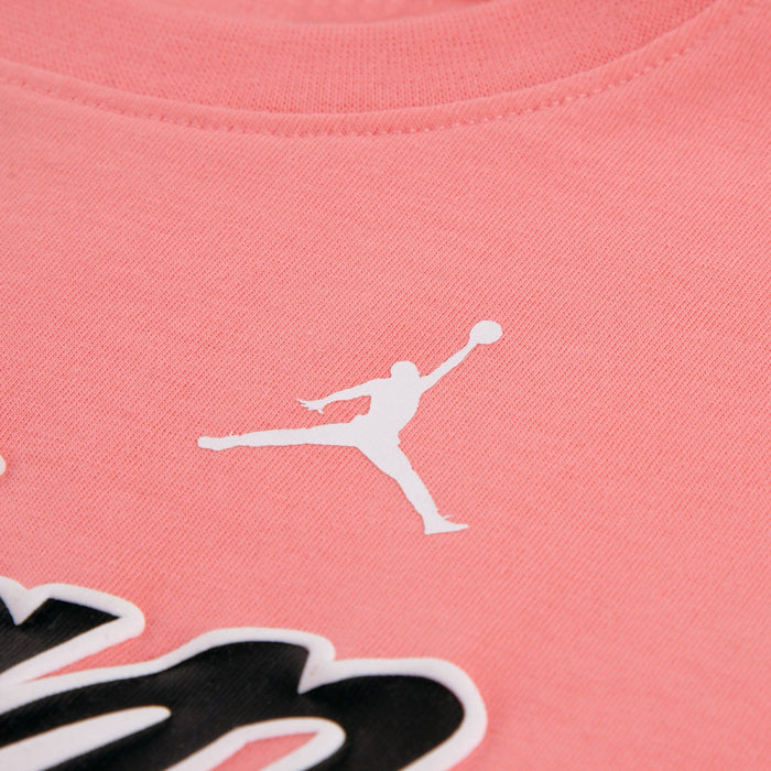 Jordan kids' pink t-shirt showing close-up of printed logo on chest.