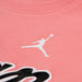 Jordan kids' pink t-shirt showing close-up of printed logo on chest.